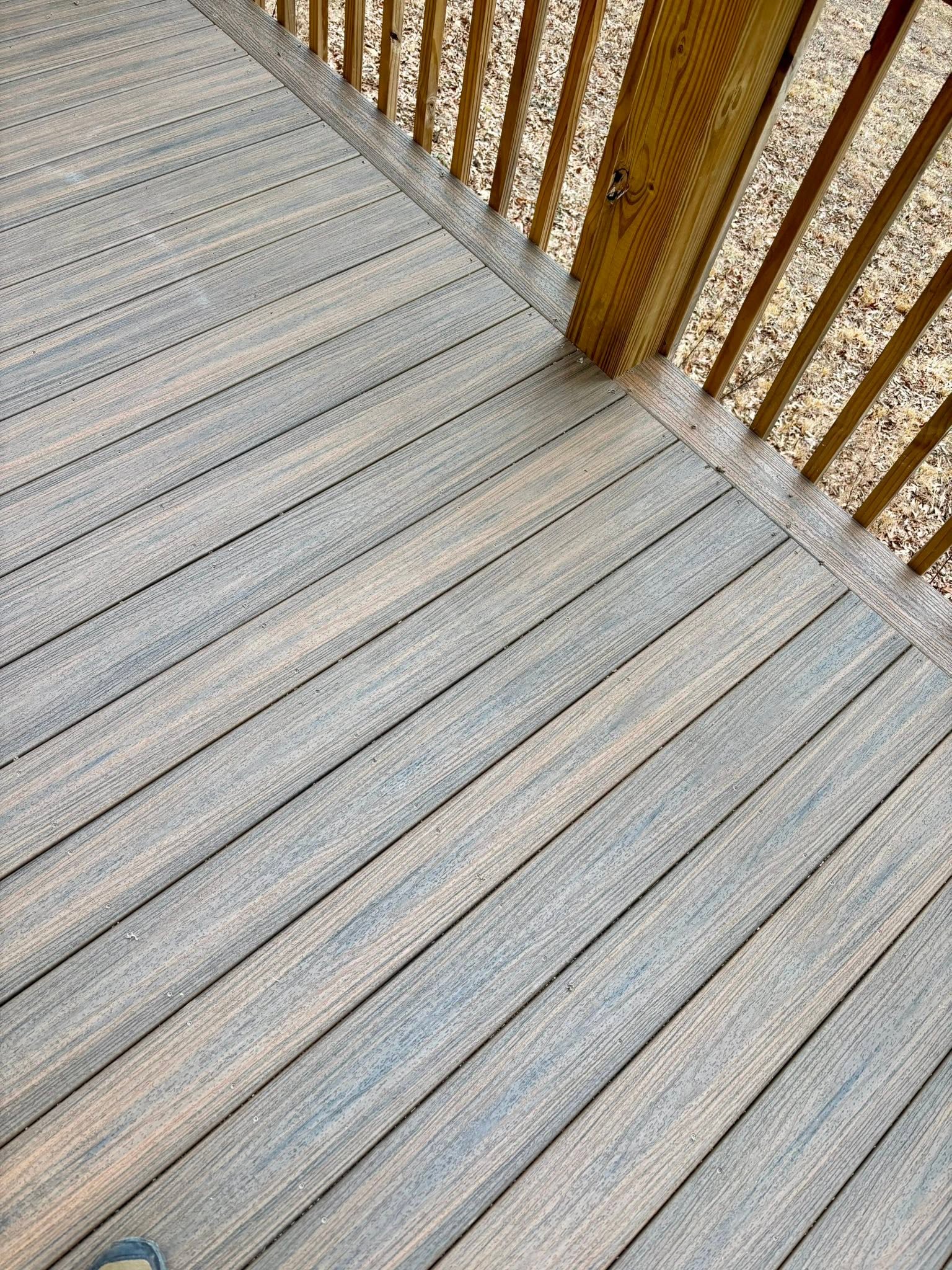 Gray composite re-decking and wood railing detail in Union County, GA Gray composite re-decking and wood railing detail in Union County, GA